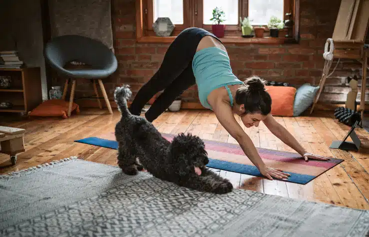 Woman doing yoga with her dog Willow Chiropractic